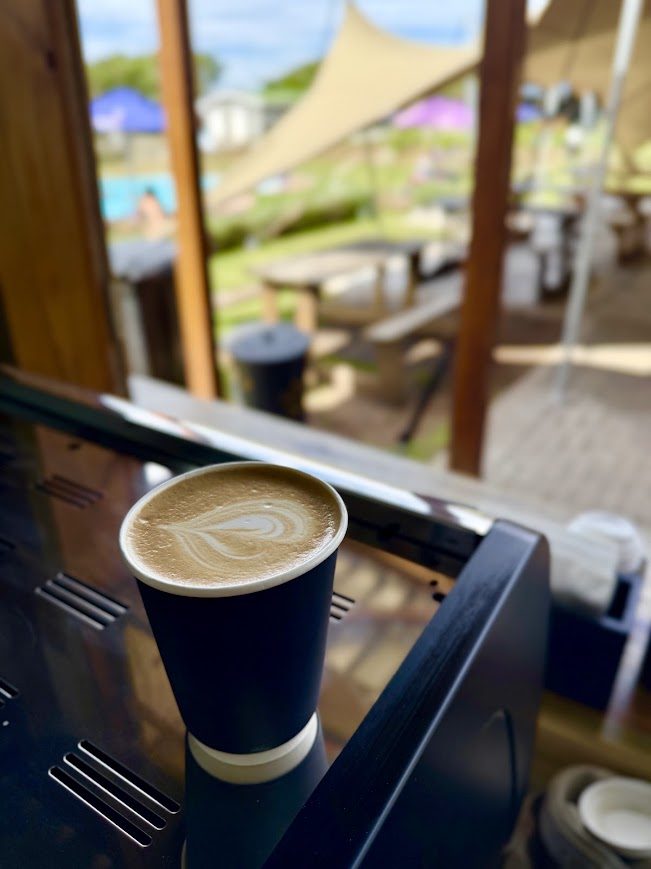 A flat white at Yellow's Bru, overlooking the pool