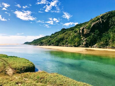 Clear turquoise water and sandbanks at the Kwelera River mouth